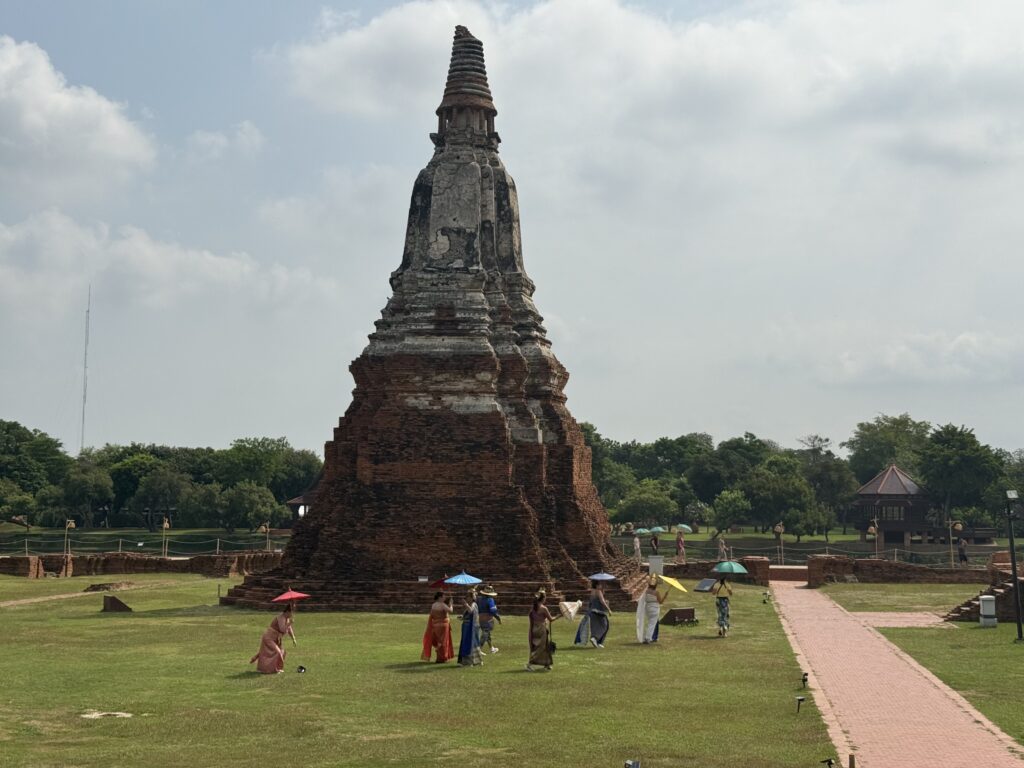 A tall, ancient stupa stands proudly in the background, showcasing its historical significance.